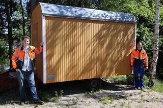 Bauhofleiter André Kaudel (links) und Projektleiter Florian Marx stellen den jungen Leuten, die bei dem Projekt mitarbeiten möchten, diesen Bauwagen für ihre Besprechungen und Pausen zur Verfügung.